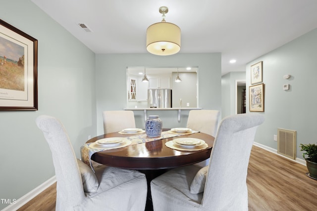 720 Springfork Dr, Cary, NC 27513 - dining room with light wood finished floors and baseboards