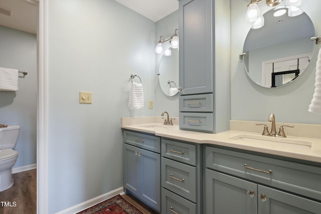720 Springfork Dr, Cary, NC 27513 - bathroom featuring double vanity and wood finished floors