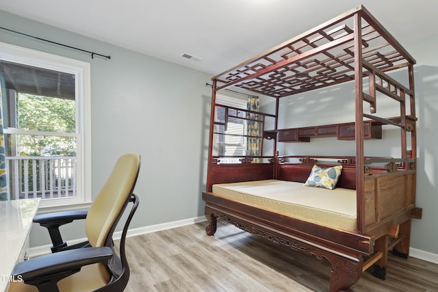 720 Springfork Dr, Cary, NC 27513 - bedroom with multiple windows and light wood-style flooring
