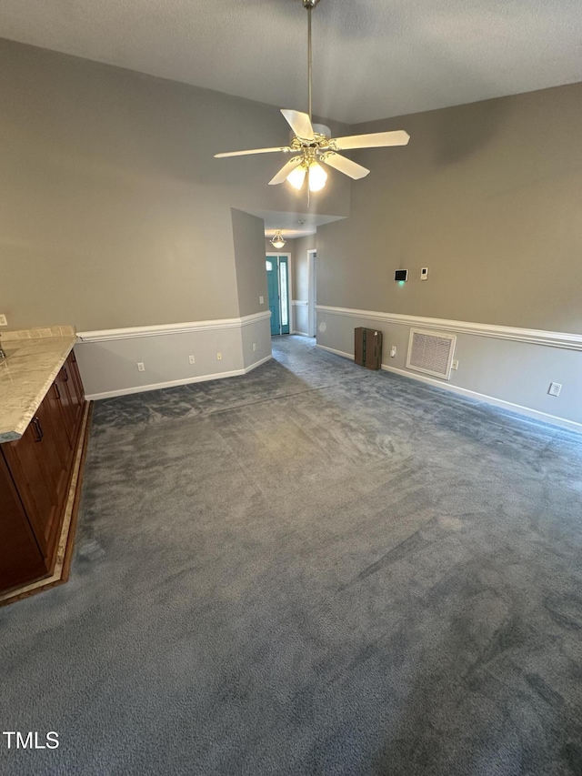 216 Parrish Farm Ln, Benson, NC 27504 - unfurnished living room featuring dark colored carpet and a ceiling fan
