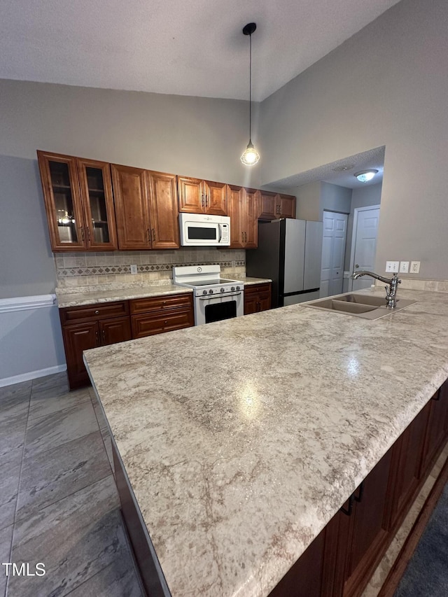 216 Parrish Farm Ln, Benson, NC 27504 - kitchen featuring white appliances, high vaulted ceiling, a peninsula, decorative backsplash, and light countertops