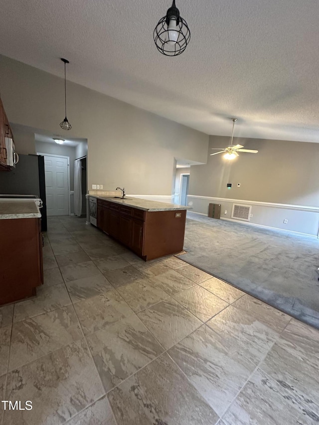 216 Parrish Farm Ln, Benson, NC 27504 - kitchen with a textured ceiling, light carpet, ceiling fan, decorative light fixtures, and vaulted ceiling