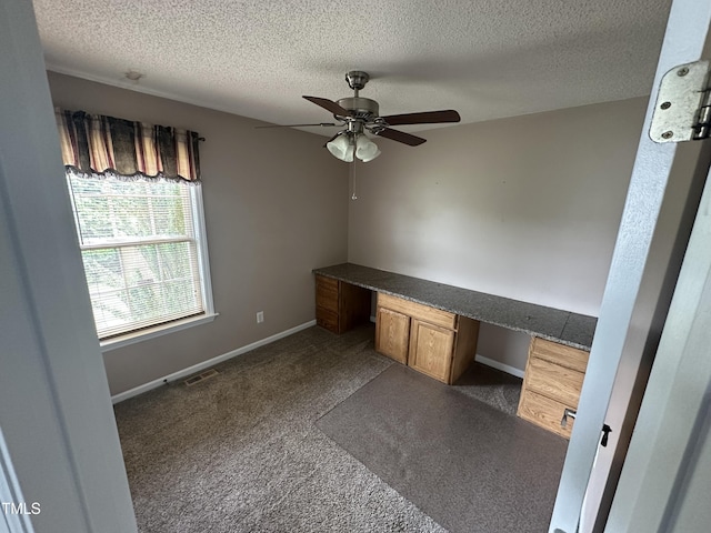 216 Parrish Farm Ln, Benson, NC 27504 - unfurnished office with built in study area, a textured ceiling, ceiling fan, and dark colored carpet