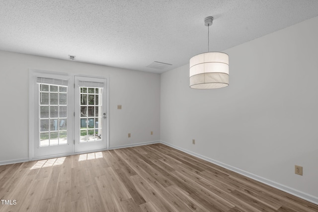 82 Forest Oaks Dr, Durham, NC 27705 - spare room with a textured ceiling and wood finished floors