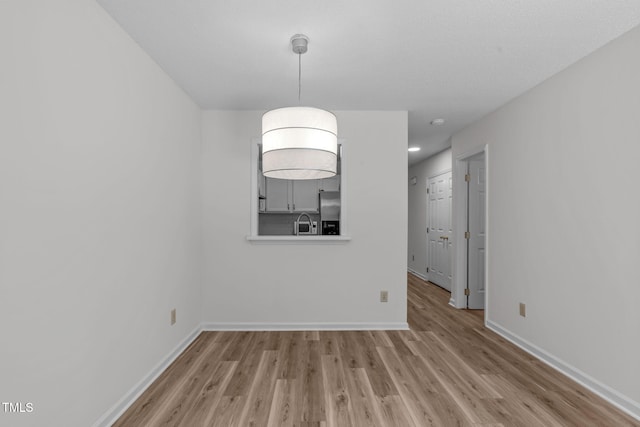 82 Forest Oaks Dr, Durham, NC 27705 - unfurnished dining area with wood finished floors and baseboards