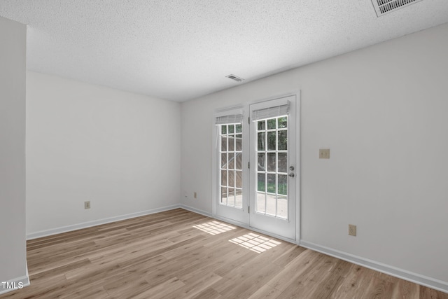 82 Forest Oaks Dr, Durham, NC 27705 - spare room with light wood-style flooring and a textured ceiling