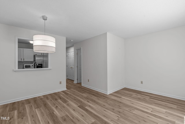 82 Forest Oaks Dr, Durham, NC 27705 - unfurnished living room with wood finished floors and baseboards