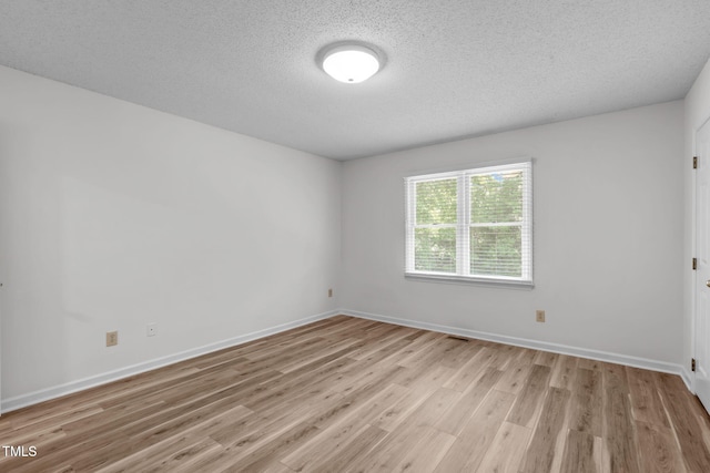 82 Forest Oaks Dr, Durham, NC 27705 - empty room featuring light wood-type flooring and a textured ceiling