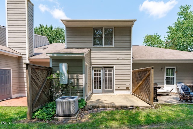 82 Forest Oaks Dr, Durham, NC 27705 - back of property featuring a patio, a shingled roof, a gate, and an outdoor fire pit