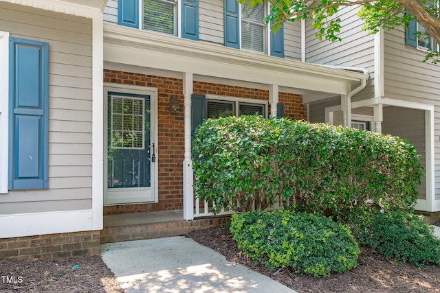 82 Forest Oaks Dr, Durham, NC 27705 - property entrance featuring a porch and brick siding