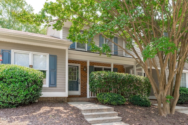 82 Forest Oaks Dr, Durham, NC 27705 - property entrance with covered porch and brick siding