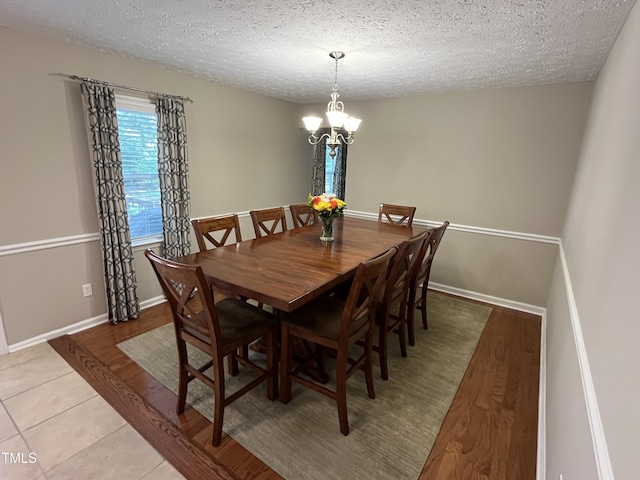 106 Carmel Woods Ct, Wake Forest, NC 27587 - dining room featuring a textured ceiling, a chandelier, and light tile patterned floors
