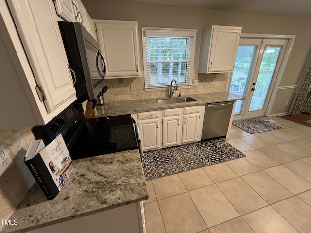 106 Carmel Woods Ct, Wake Forest, NC 27587 - kitchen with stainless steel appliances, white cabinets, decorative backsplash, light tile patterned floors, and light stone counters