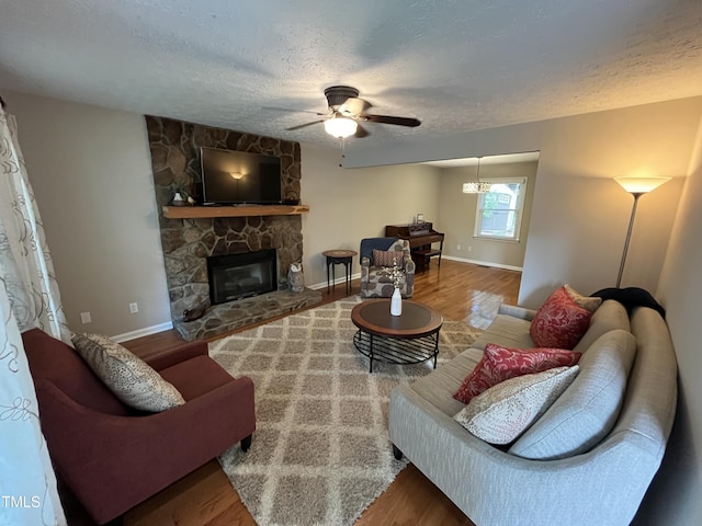 106 Carmel Woods Ct, Wake Forest, NC 27587 - living area featuring a ceiling fan, a textured ceiling, a fireplace, and wood finished floors