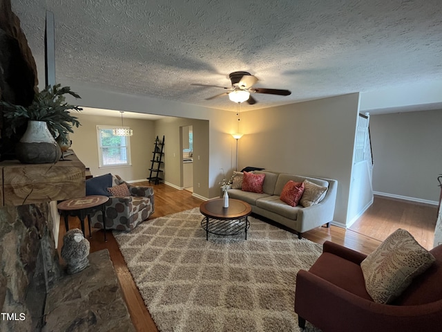 106 Carmel Woods Ct, Wake Forest, NC 27587 - living room featuring wood finished floors, a textured ceiling, and a ceiling fan