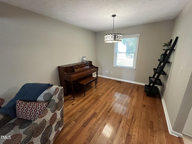 106 Carmel Woods Ct, Wake Forest, NC 27587 - sitting room featuring wood finished floors and a textured ceiling