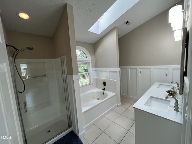 106 Carmel Woods Ct, Wake Forest, NC 27587 - full bath with a skylight, a shower stall, a jetted tub, tile patterned flooring, and wainscoting