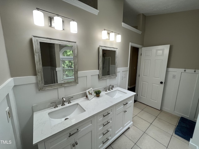 106 Carmel Woods Ct, Wake Forest, NC 27587 - full bathroom featuring double vanity, tile patterned floors, and wainscoting