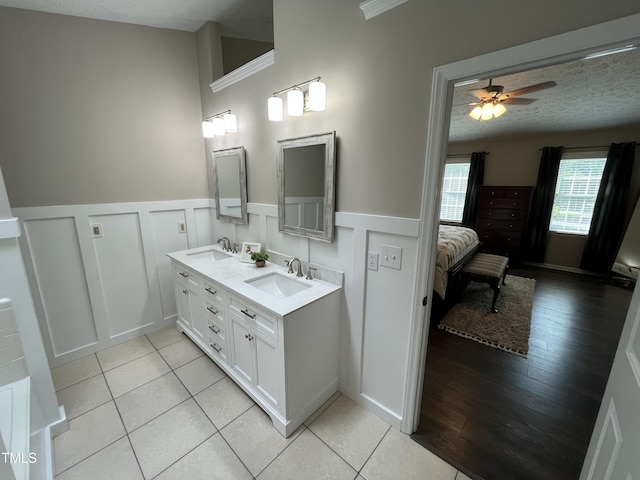 106 Carmel Woods Ct, Wake Forest, NC 27587 - full bath with double vanity, wainscoting, a decorative wall, a ceiling fan, and tile patterned flooring