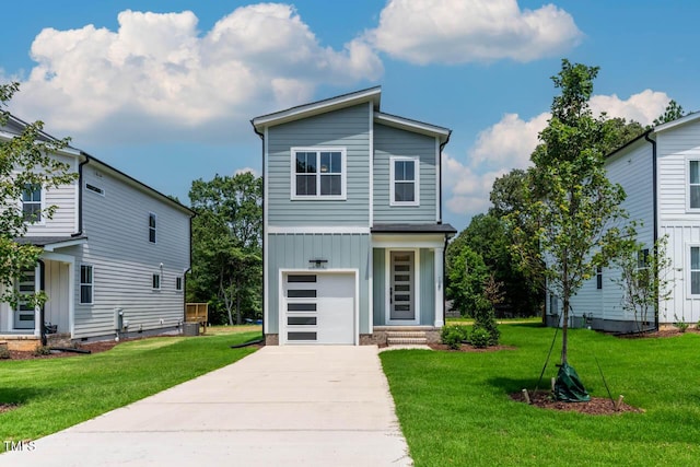 136 E End Ave, Durham, NC 27703 - view of front of home featuring board and batten siding, driveway, a front yard, and a garage