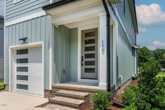 136 E End Ave, Durham, NC 27703 - doorway to property with board and batten siding and a garage
