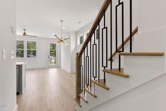 136 E End Ave, Durham, NC 27703 - staircase featuring wood finished floors, a chandelier, and ceiling fan