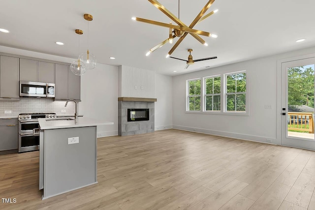 136 E End Ave, Durham, NC 27703 - kitchen featuring gray cabinetry, appliances with stainless steel finishes, a chandelier, healthy amount of natural light, and recessed lighting