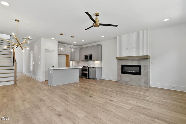 136 E End Ave, Durham, NC 27703 - kitchen featuring gray cabinets, appliances with stainless steel finishes, open floor plan, light wood finished floors, and light countertops