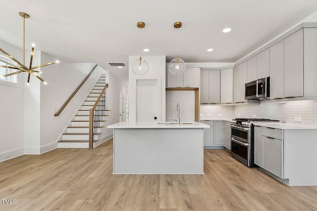 136 E End Ave, Durham, NC 27703 - kitchen featuring appliances with stainless steel finishes, a chandelier, backsplash, light countertops, and recessed lighting
