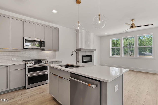 136 E End Ave, Durham, NC 27703 - kitchen featuring appliances with stainless steel finishes, gray cabinetry, tasteful backsplash, light countertops, and recessed lighting