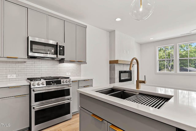 136 E End Ave, Durham, NC 27703 - kitchen with gray cabinetry, appliances with stainless steel finishes, light countertops, and recessed lighting