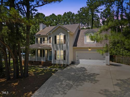 6425 Cross Ridge Dr, Holly Springs, NC 27540 - colonial inspired home with covered porch, driveway, and a chimney