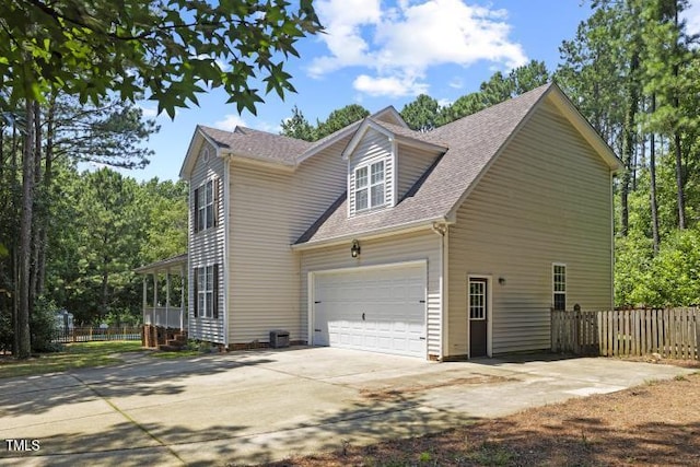 6425 Cross Ridge Dr, Holly Springs, NC 27540 - view of side of home with driveway, an attached garage, and roof with shingles