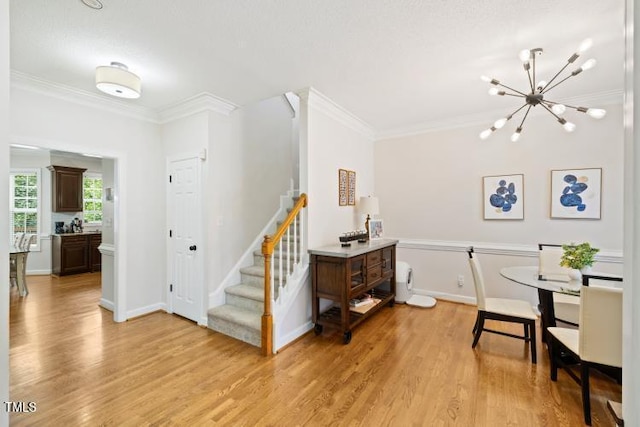 6425 Cross Ridge Dr, Holly Springs, NC 27540 - dining space with ornamental molding, a chandelier, light wood-style flooring, and stairs