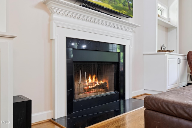 6425 Cross Ridge Dr, Holly Springs, NC 27540 - detailed view of a warm lit fireplace and wood finished floors