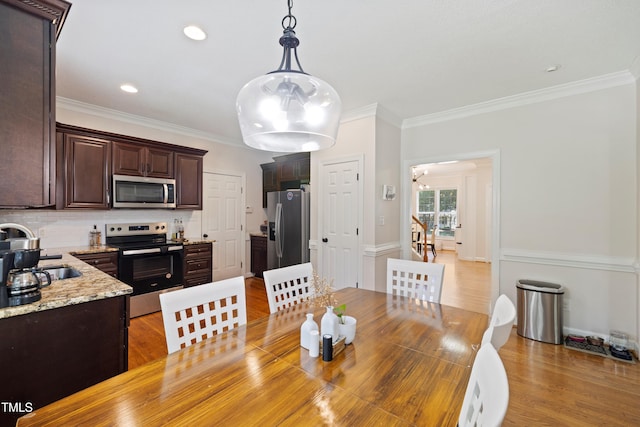 6425 Cross Ridge Dr, Holly Springs, NC 27540 - dining space with crown molding and light wood finished floors