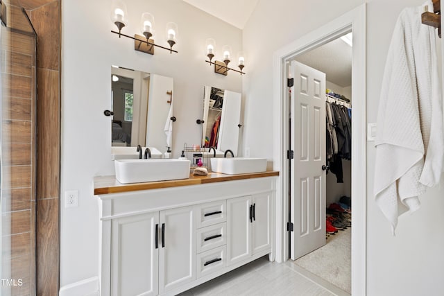 6425 Cross Ridge Dr, Holly Springs, NC 27540 - ensuite bathroom with double vanity, a spacious closet, and tile patterned flooring