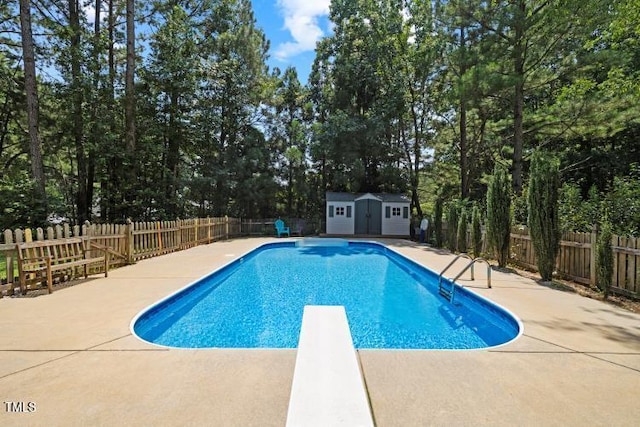 6425 Cross Ridge Dr, Holly Springs, NC 27540 - view of swimming pool featuring a diving board, a patio, a fenced backyard, a storage shed, and view of scattered trees