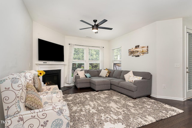155 Writing Rock Pl, Apex, NC 27539 - living area with dark wood-type flooring, a ceiling fan, and a glass covered fireplace