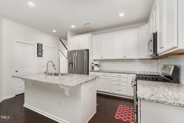 155 Writing Rock Pl, Apex, NC 27539 - kitchen with appliances with stainless steel finishes, dark wood-style flooring, white cabinets, decorative backsplash, and recessed lighting