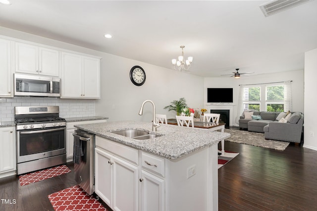 155 Writing Rock Pl, Apex, NC 27539 - kitchen featuring appliances with stainless steel finishes, recessed lighting, backsplash, dark wood-style floors, and a ceiling fan