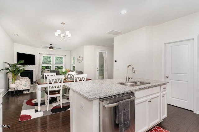 155 Writing Rock Pl, Apex, NC 27539 - kitchen featuring stainless steel dishwasher, dark wood finished floors, a fireplace, a chandelier, and recessed lighting