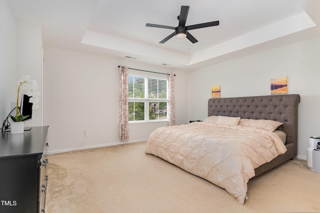 155 Writing Rock Pl, Apex, NC 27539 - bedroom with light colored carpet, a tray ceiling, and a ceiling fan