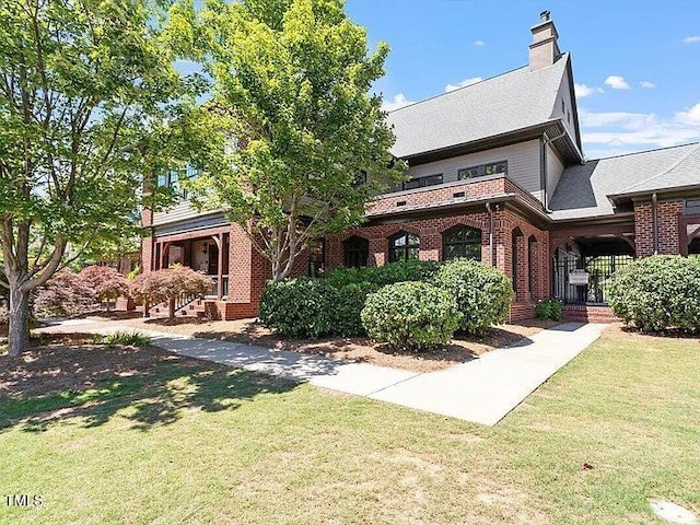 155 Writing Rock Pl, Apex, NC 27539 - view of front of property with brick siding, a front yard, and a chimney