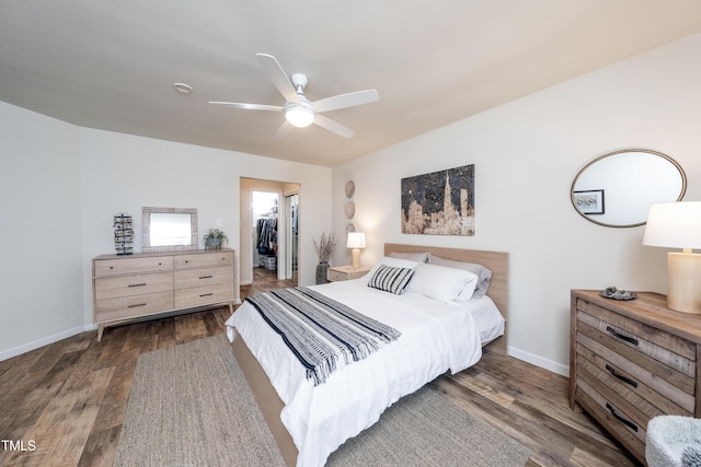 506 Cottage Ln, Durham, NC 27713 - bedroom with a walk in closet, wood finished floors, and a ceiling fan