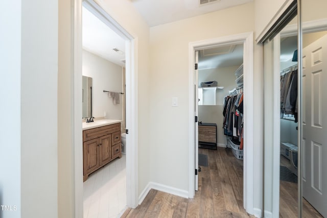 506 Cottage Ln, Durham, NC 27713 - corridor with light wood-style floors and a sink