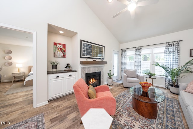 506 Cottage Ln, Durham, NC 27713 - living room featuring high vaulted ceiling, a ceiling fan, a glass covered fireplace, light wood-type flooring, and recessed lighting