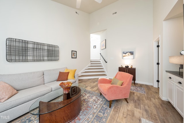 506 Cottage Ln, Durham, NC 27713 - living area with wood finished floors, stairs, a high ceiling, and ceiling fan