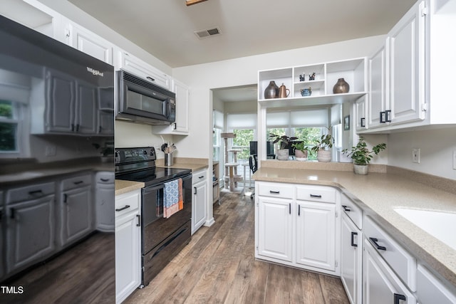 506 Cottage Ln, Durham, NC 27713 - kitchen with black appliances, white cabinets, open shelves, light countertops, and wood finished floors