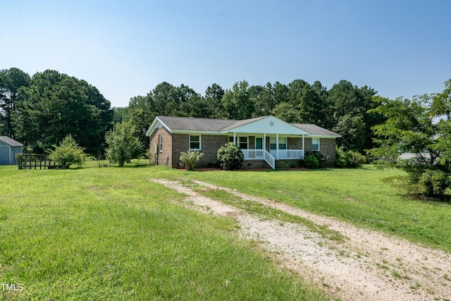 5840 Rocking Chair Dr, Youngsville, NC 27596 - single story home featuring a porch, a front yard, driveway, and brick siding